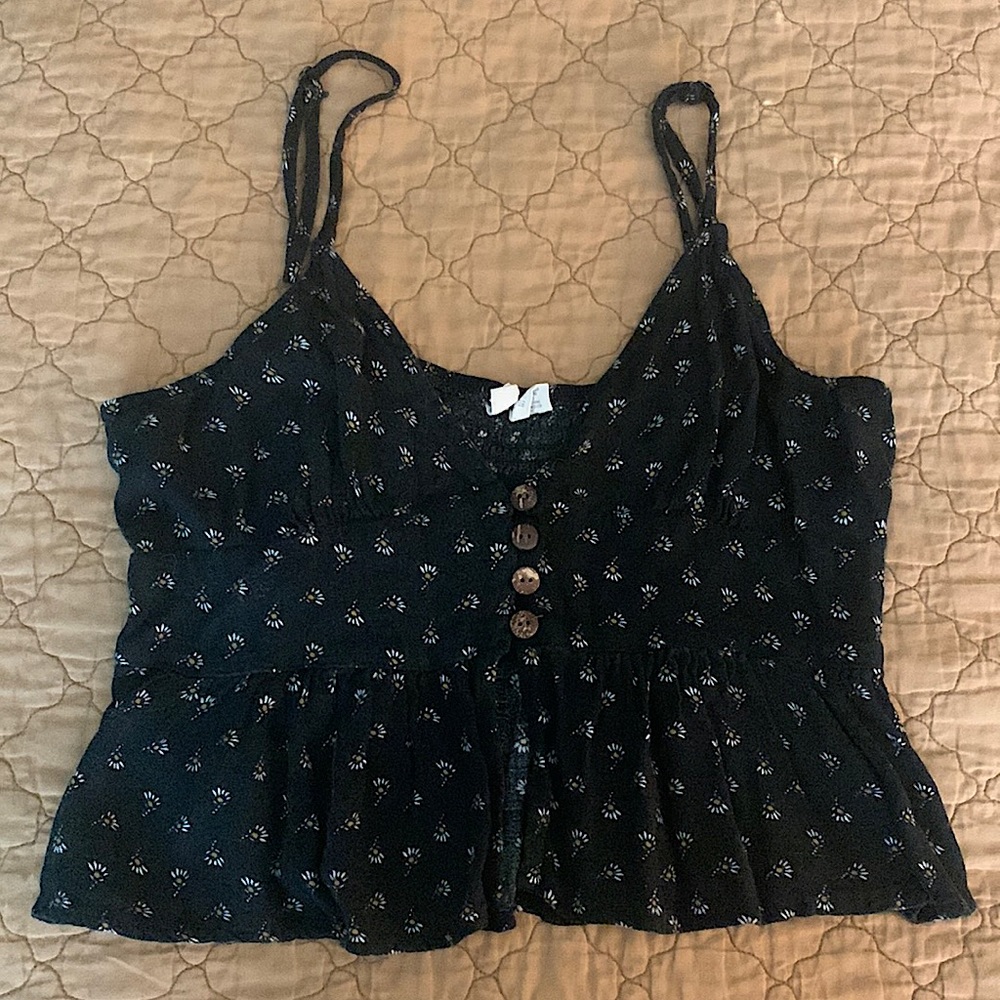 Black cropped tank top with an open slit in the front. Brand is Sky and Sparrow.
